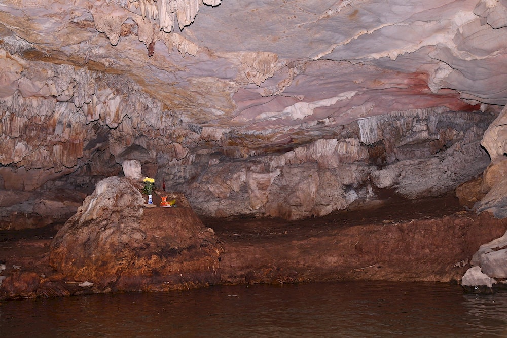 A naturally formed Buddha-shaped stalactite creates a sacred and mysterious atmosphere 
